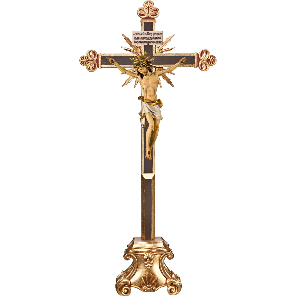Cristo Pisa en cruz barroca con rayos en peana y Titulus Crucis en hebreo - latín - griego